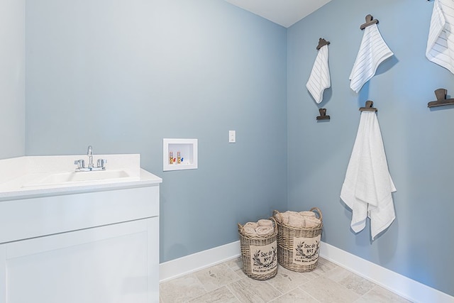 laundry room featuring a sink, baseboards, laundry area, and washer hookup