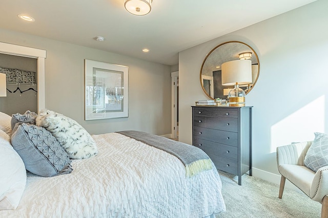 carpeted bedroom featuring baseboards and recessed lighting