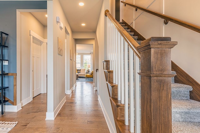interior space with recessed lighting, wood-type flooring, baseboards, and stairway
