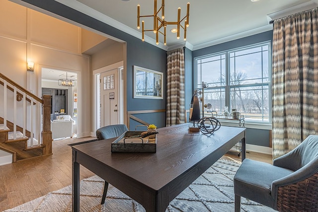 office featuring a chandelier, crown molding, wood finished floors, and baseboards