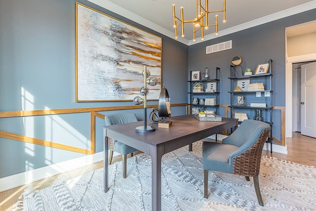 office area featuring ornamental molding, visible vents, a chandelier, wood finished floors, and baseboards