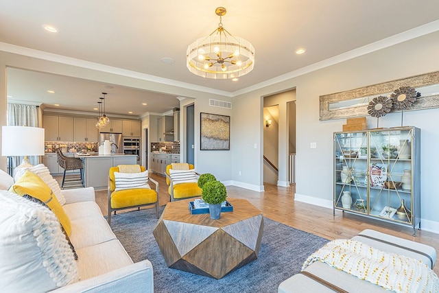 living room with visible vents, baseboards, recessed lighting, and a chandelier