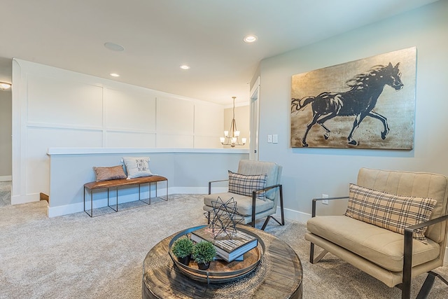 sitting room with a chandelier, baseboards, carpet, and recessed lighting