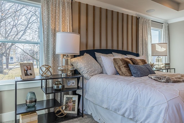 bedroom featuring crown molding and wallpapered walls