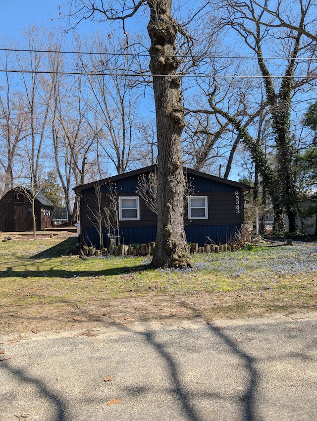 view of front of property featuring a storage unit and an outdoor structure
