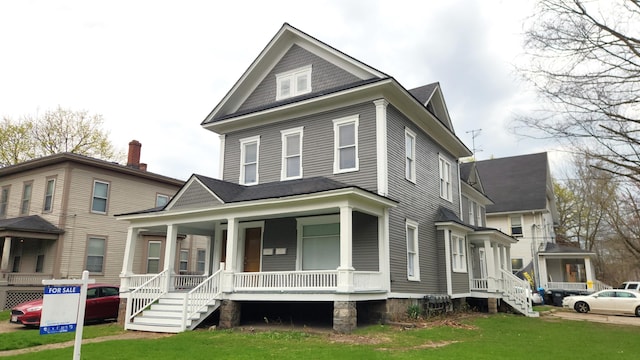 320 W Vine St, Kalamazoo, MI 49001 - view of front of house with a porch, a front lawn, and stairway