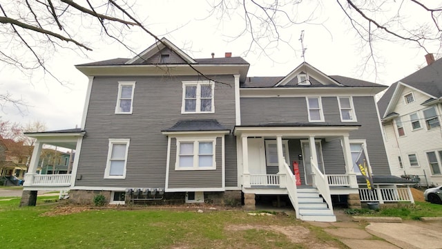 320 W Vine St, Kalamazoo, MI 49001 - view of front of property with covered porch, a chimney, and a front lawn