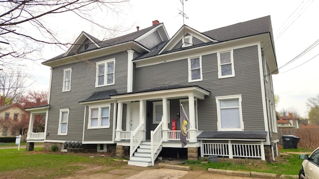 320 W Vine St, Kalamazoo, MI 49001 - victorian-style house with a porch, roof with shingles, and a chimney
