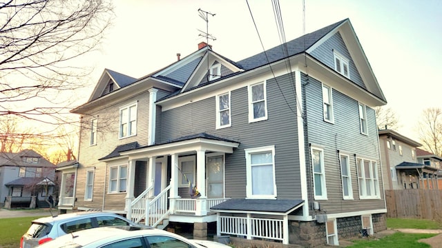 320 W Vine St, Kalamazoo, MI 49001 - view of front of house featuring a porch, a chimney, and fence