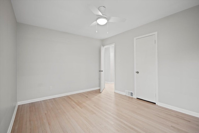 spare room with visible vents, baseboards, ceiling fan, and wood finished floors