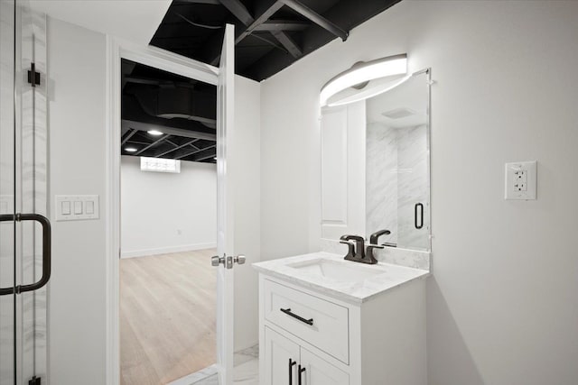 bathroom with a shower stall, marble finish floor, and vanity