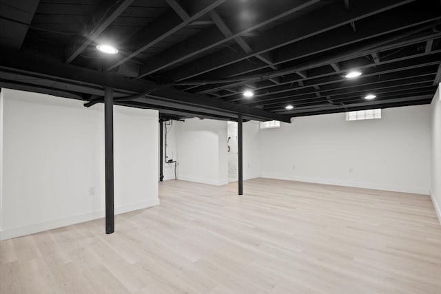 below grade area with light wood-type flooring and baseboards