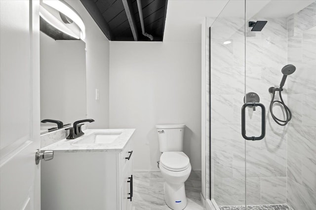 bathroom featuring toilet, vanity, marble finish floor, and a stall shower