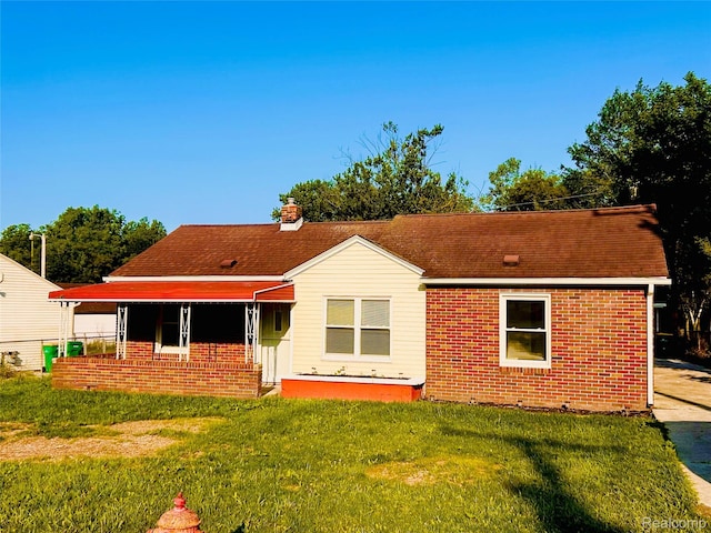25590 Middlebelt Rd, Flat Rock, MI 48134 - back of property featuring brick siding, a yard, and a shingled roof