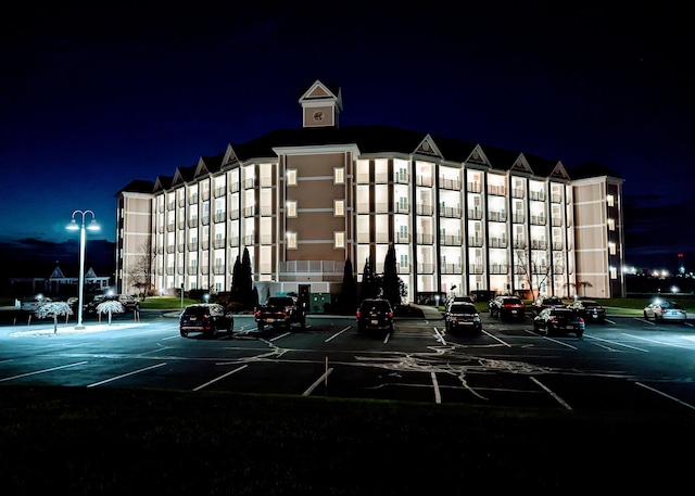 property at twilight with uncovered parking