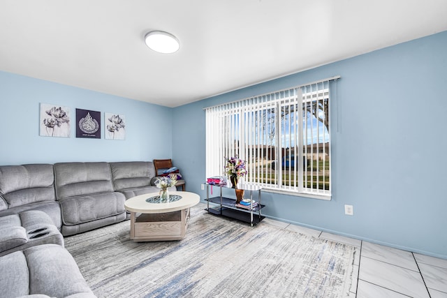 living area featuring baseboards