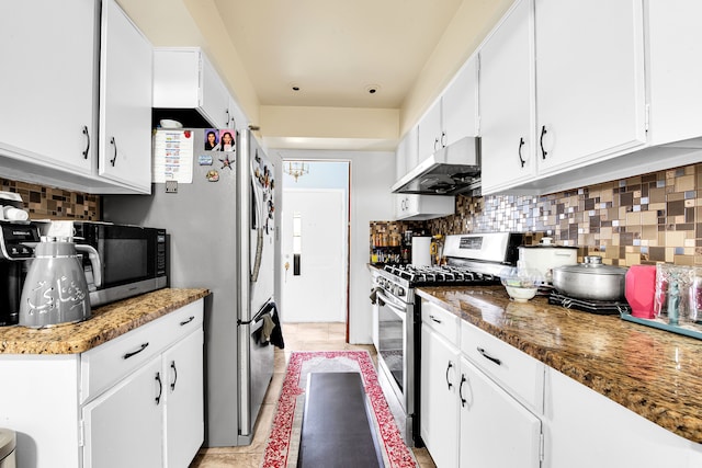 kitchen featuring white cabinets, appliances with stainless steel finishes, under cabinet range hood, backsplash, and light tile patterned flooring