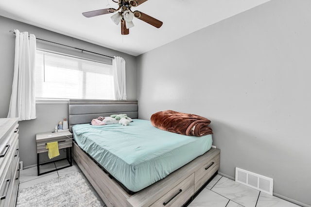 bedroom featuring marble finish floor, baseboards, a ceiling fan, and visible vents