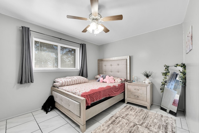 bedroom featuring baseboards and a ceiling fan