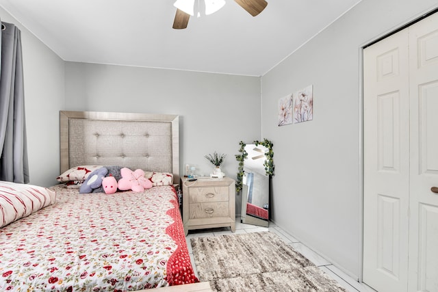 tiled bedroom with a ceiling fan