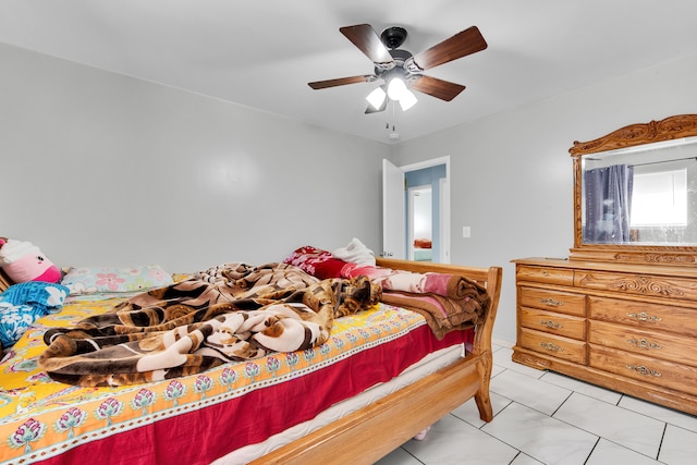 bedroom featuring light tile patterned flooring and ceiling fan
