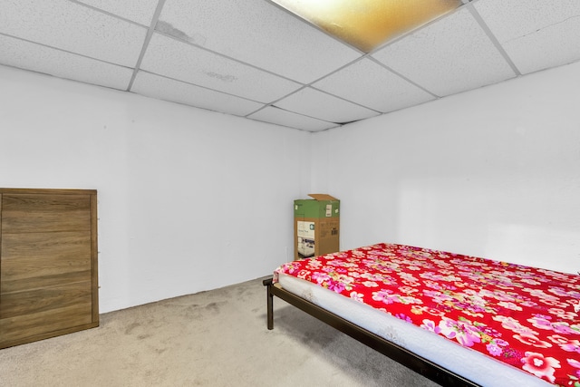 carpeted bedroom featuring a paneled ceiling