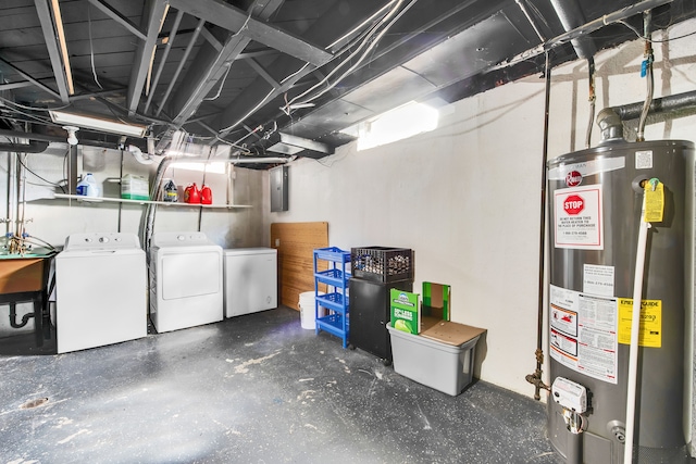 unfinished below grade area featuring washer and dryer, electric panel, a sink, fridge, and gas water heater