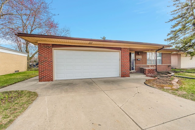 single story home with a garage, brick siding, and driveway