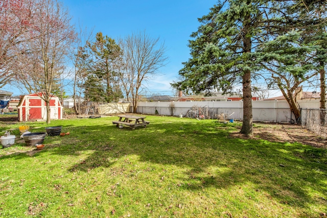 view of yard featuring a fenced backyard, an outdoor structure, and a storage unit