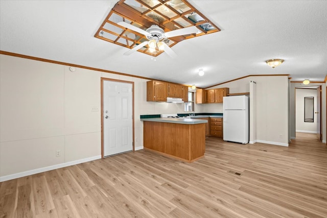 22600 Middlebelt Rd Lot F-28, Farmington Hills, MI 48336 - kitchen with a peninsula, freestanding refrigerator, under cabinet range hood, light wood-style floors, and brown cabinetry