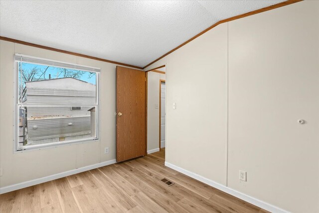 22600 Middlebelt Rd Lot F-28, Farmington Hills, MI 48336 - unfurnished room featuring crown molding, wood finished floors, visible vents, and a textured ceiling