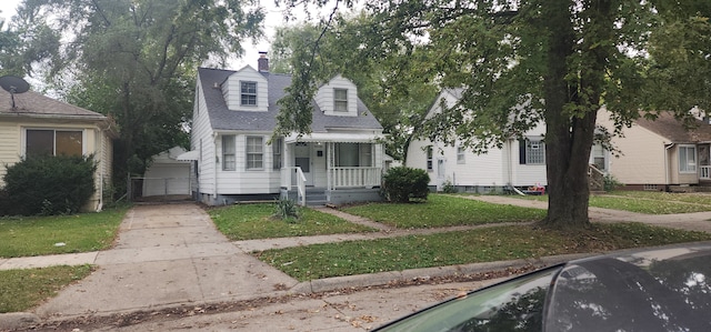 18580 Kingsville St, Harper Woods, MI 48225 - cape cod home featuring a chimney, a front lawn, and covered porch