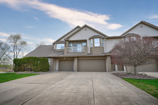 10025 Sunrise Dr, Grand Blanc, MI 48439 - multi unit property with driveway, a balcony, a garage, and a shingled roof