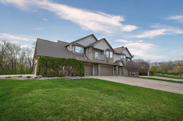 10025 Sunrise Dr, Grand Blanc, MI 48439 - view of front of house with an attached garage, driveway, a balcony, a front lawn, and roof with shingles