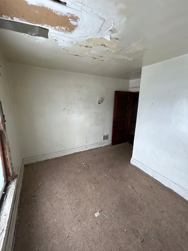 unfurnished room with carpet flooring and baseboards