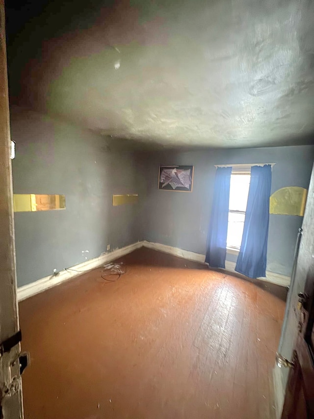 unfurnished room featuring baseboards