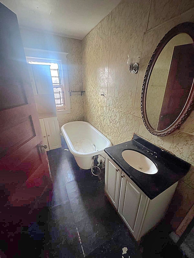 full bath with a freestanding bath and vanity
