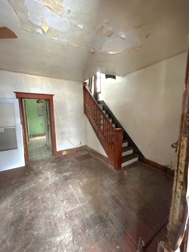 unfurnished living room with stairway