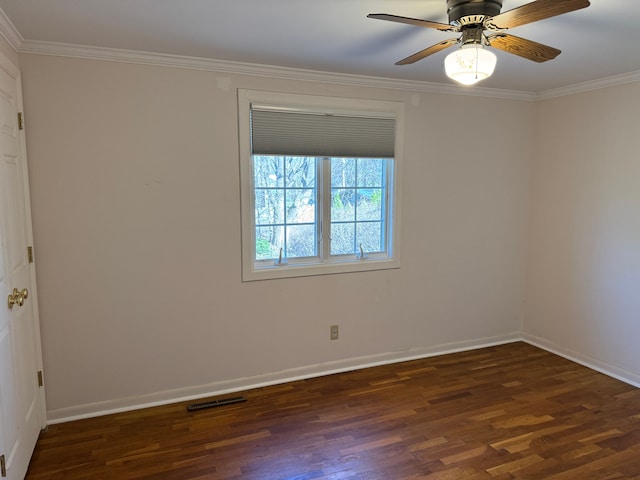 2126 Holly Tree Dr, Davison, MI 48423 - spare room featuring dark wood-style flooring, ornamental molding, baseboards, and a ceiling fan