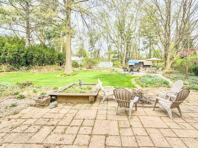 2126 Holly Tree Dr, Davison, MI 48423 - view of patio featuring a fire pit
