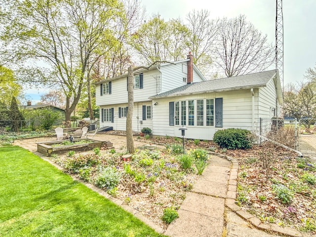 2126 Holly Tree Dr, Davison, MI 48423 - view of front of home featuring a chimney and a vegetable garden