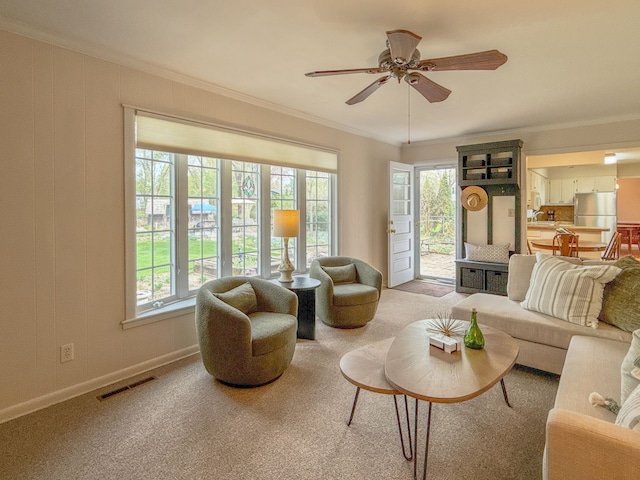 2126 Holly Tree Dr, Davison, MI 48423 - carpeted living area featuring ornamental molding, plenty of natural light, a ceiling fan, and baseboards