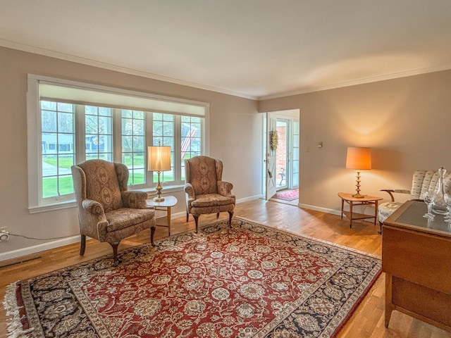 2126 Holly Tree Dr, Davison, MI 48423 - living area featuring ornamental molding, healthy amount of natural light, wood finished floors, and baseboards