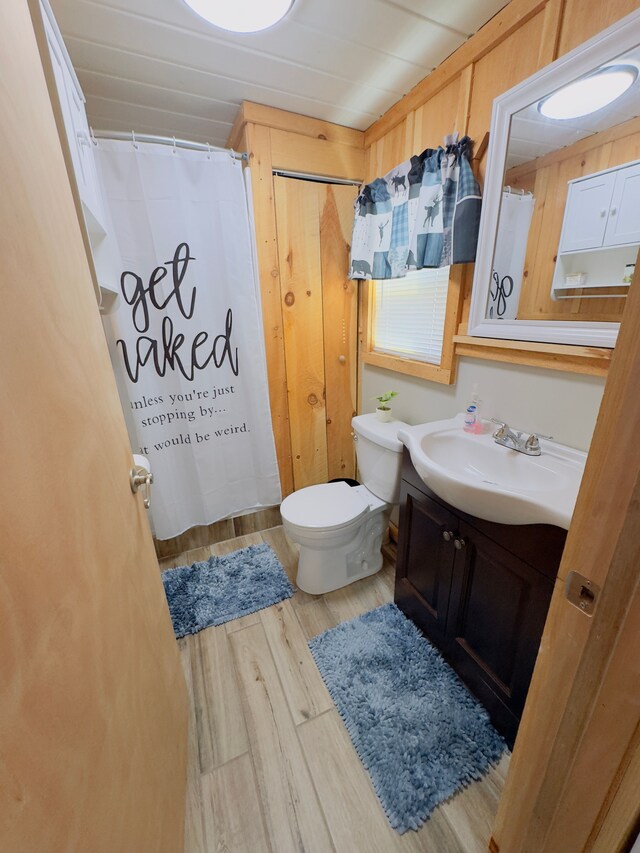 10953 Johnston Blvd, Saint Helen, MI 48656 - full bath with vanity, a shower with curtain, toilet, and wood finished floors
