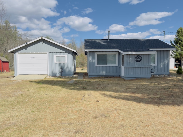 10953 Johnston Blvd, Saint Helen, MI 48656 - rear view of house with an outdoor structure, a garage, and roof with shingles