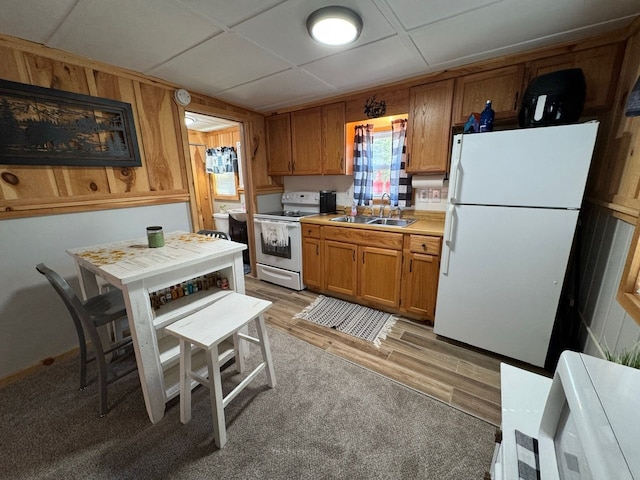 10953 Johnston Blvd, Saint Helen, MI 48656 - kitchen with a sink, light countertops, white appliances, brown cabinetry, and light wood-style flooring