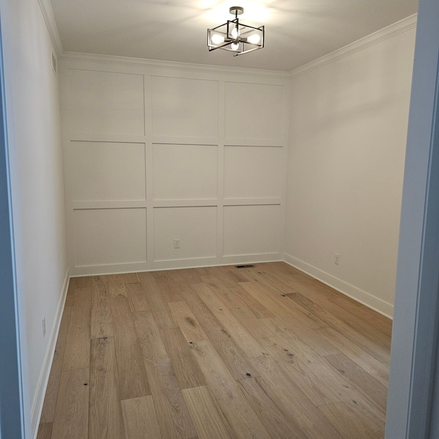 unfurnished room with baseboards, visible vents, ornamental molding, and light wood-style flooring
