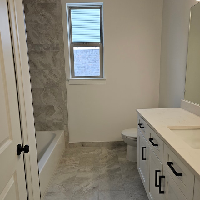 bathroom featuring toilet, baseboards, marble finish floor, and vanity