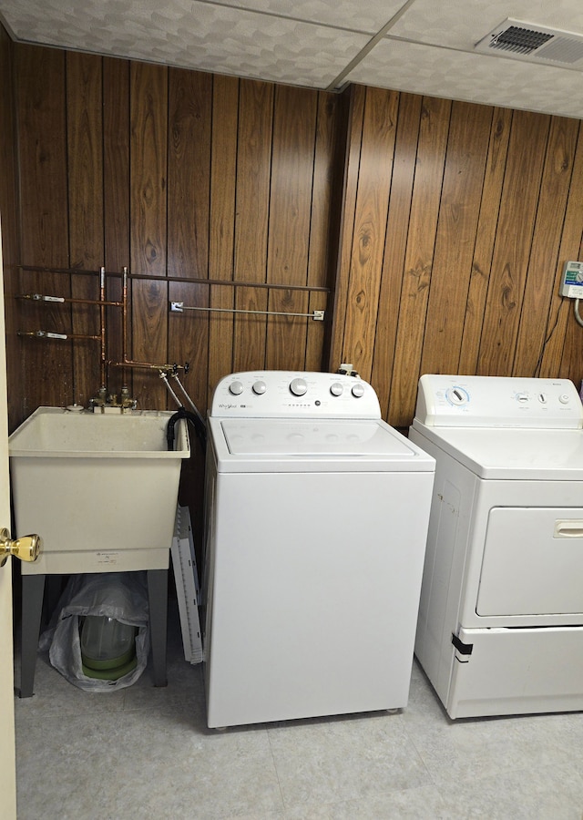 14879 Riverside St, Livonia, MI 48154 - laundry room with washing machine and dryer and wooden walls