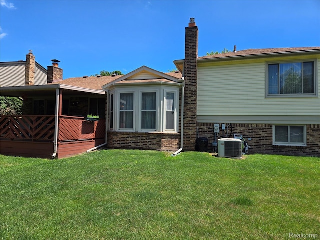 14879 Riverside St, Livonia, MI 48154 - rear view of property featuring a lawn, a wooden deck, and brick siding